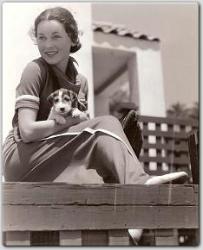Soaking up the sun at her Malibu beach home, Maureen O'Sullivan and her puppy.